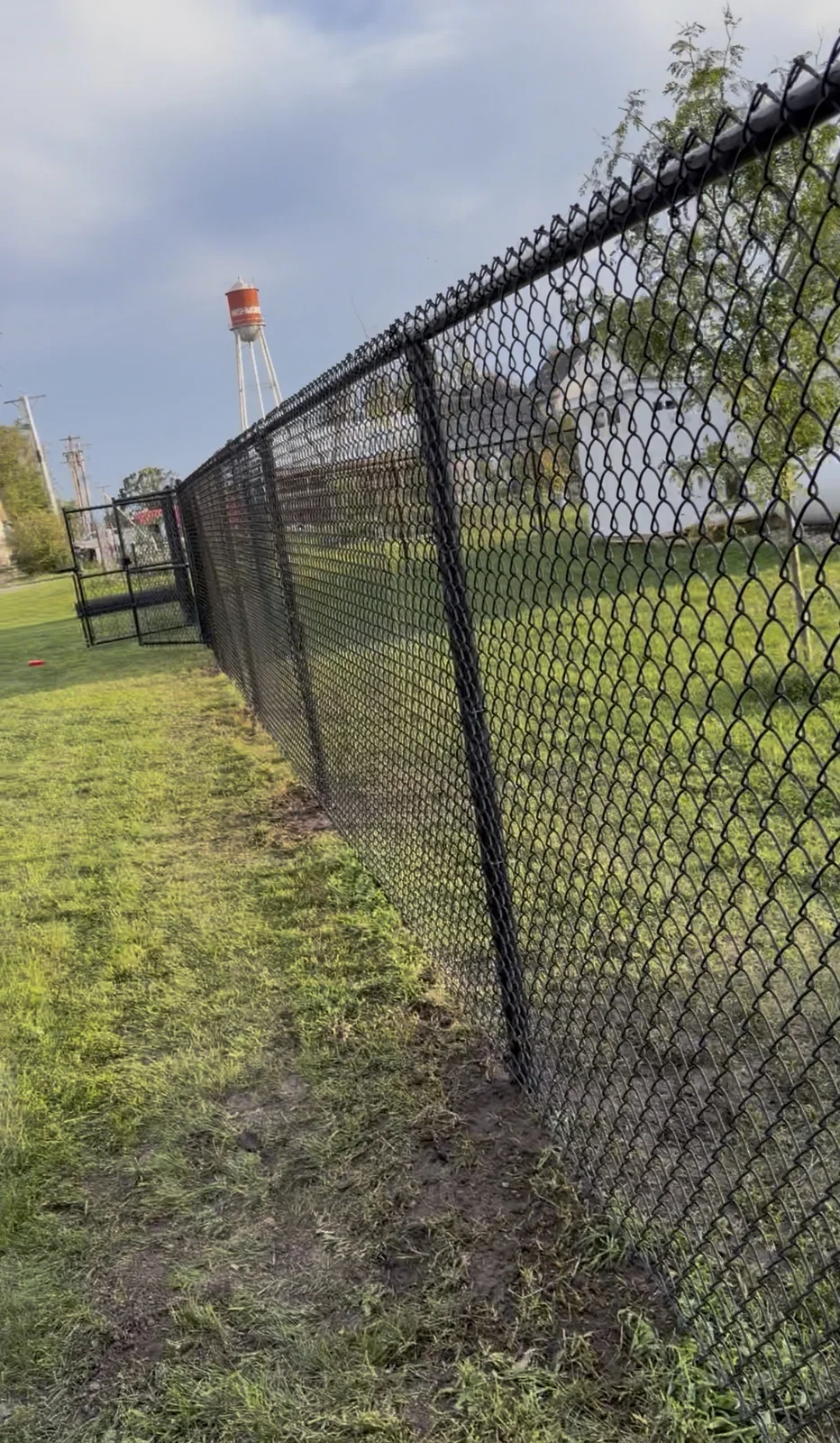 New black chain-link fence and walk gate installed by Henley Fencing