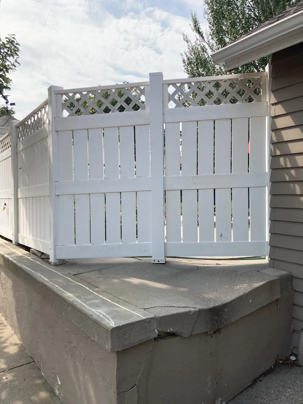 White vinyl privacy fence with lattice top repaired by Henley Fencing